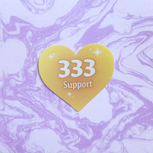 Load image into Gallery viewer, Yellow gradient heart-shaped sticker with '333 Support' white text on a marbled purple and white background.

