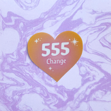 Load image into Gallery viewer, Orange and pink gradient heart-shaped sticker with '555 Change' white text on a marbled purple and white background.
