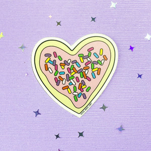 Heart-shaped frosted sugar cookie with sprinkles sticker.